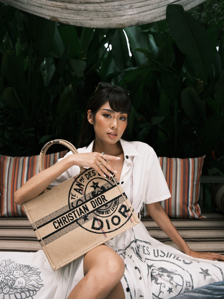 Thao Nhi Le dressed in white Dior dress paired with a beige Christian Dior bag at An Lam Retreats Saigon. Courtesy of Manh Bi @manhbi.