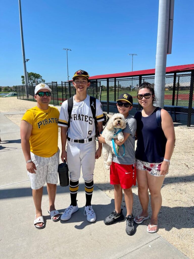 Hayden’s family: Ken,Karen, and Blake holding up Dog Coco picking up Hayden after practice Photo courtesy Ken Le.