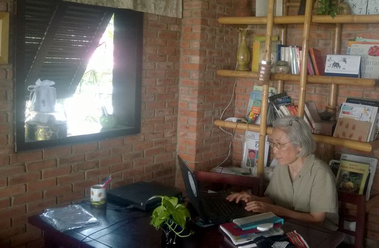 Ms. Reiko working at her computer.